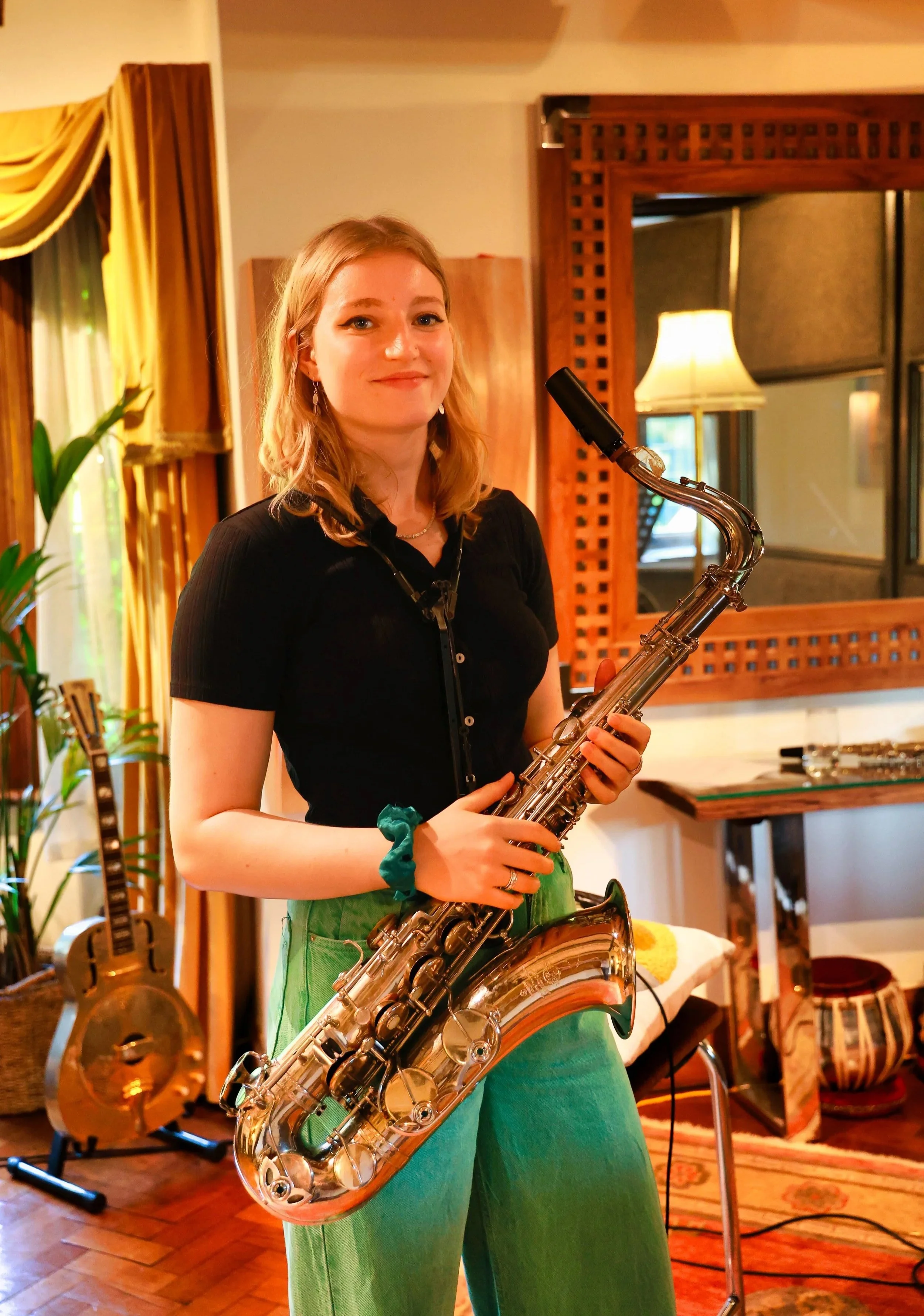 Emma Rawicz holding a saxophone at Curtis Schwartz Studio during the Big Visit sessions