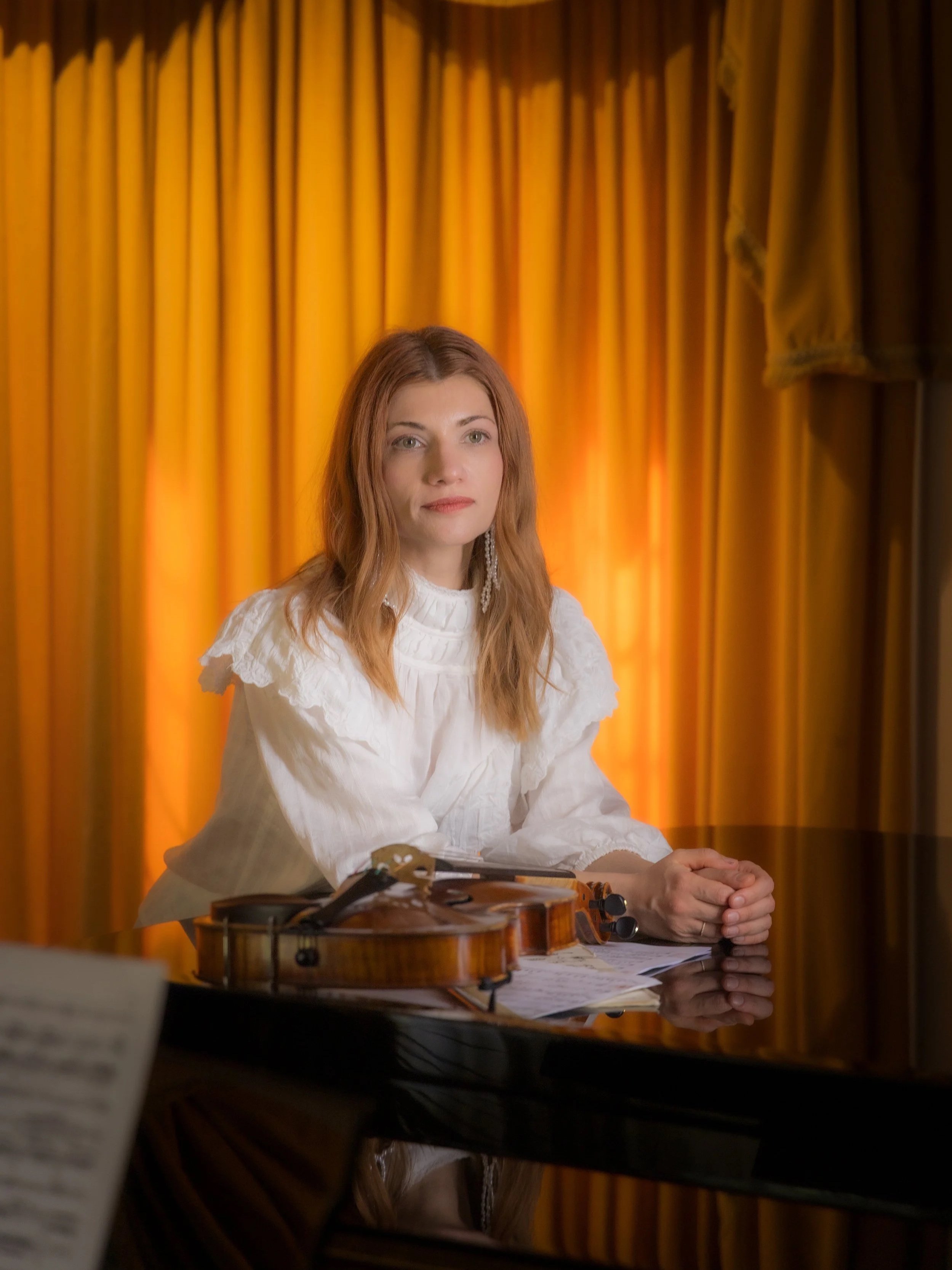 Violist Knarika Karapetjana seated with her viola during a recording session at Curtis Schwartz Studio.