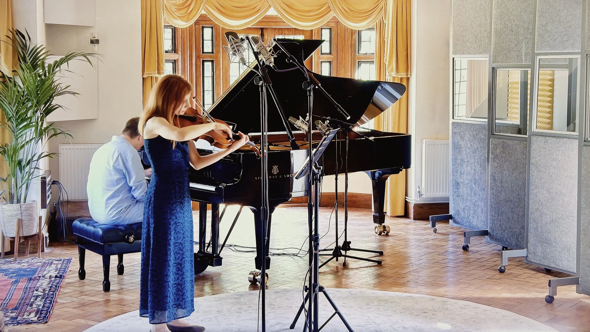 Knarika Karapetjana and Daniel Lebhardt recording viola and piano in the live room at Curtis Schwartz Studio, with the Steinway Model D and microphones set up for the session.