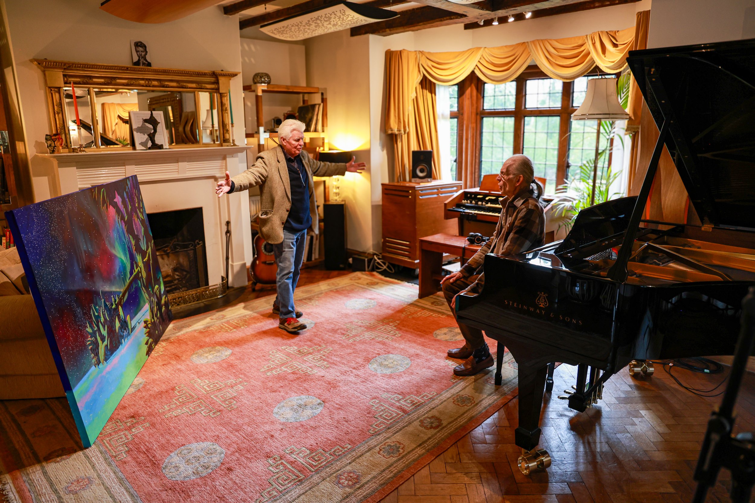 Steve Howe and Roger Dean in Curtis Schwartz Studio discussing the original artwork for YES’s forthcoming album Aurora beside a Steinway piano.