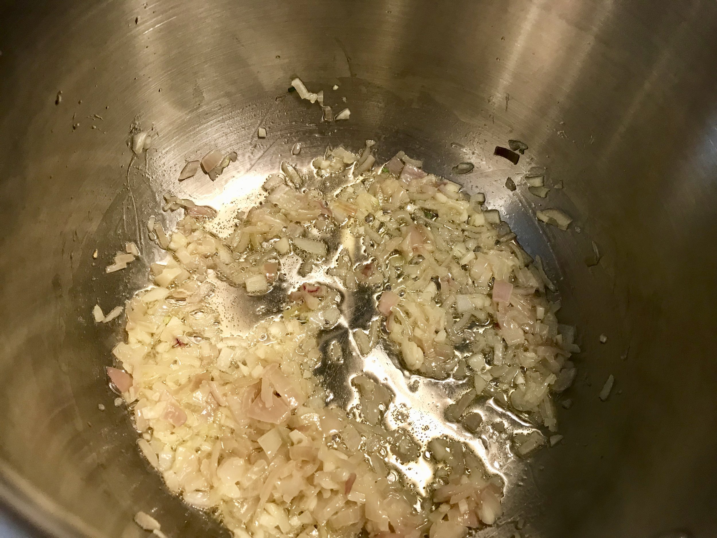 Soften the shallots and garlic in olive oil for a few minutes, stirring frequently.