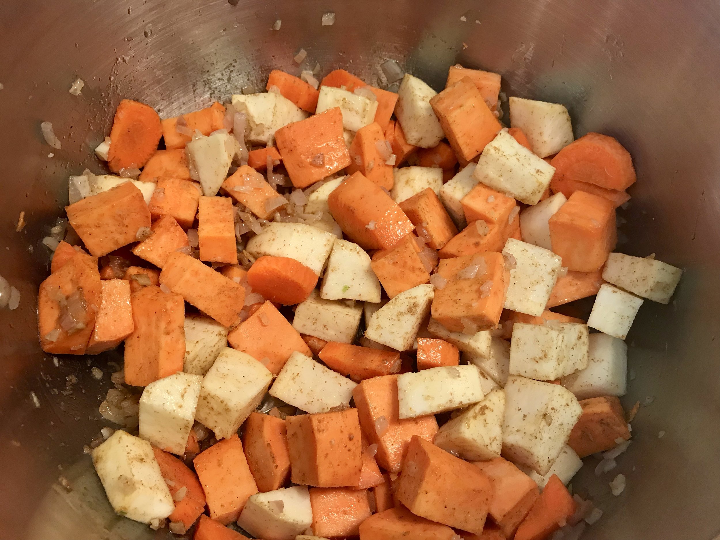 Add diced sweet potato( I used a combination of light and orange sweet potatoes) and spices and stir to combine. I also added a carrot here.
