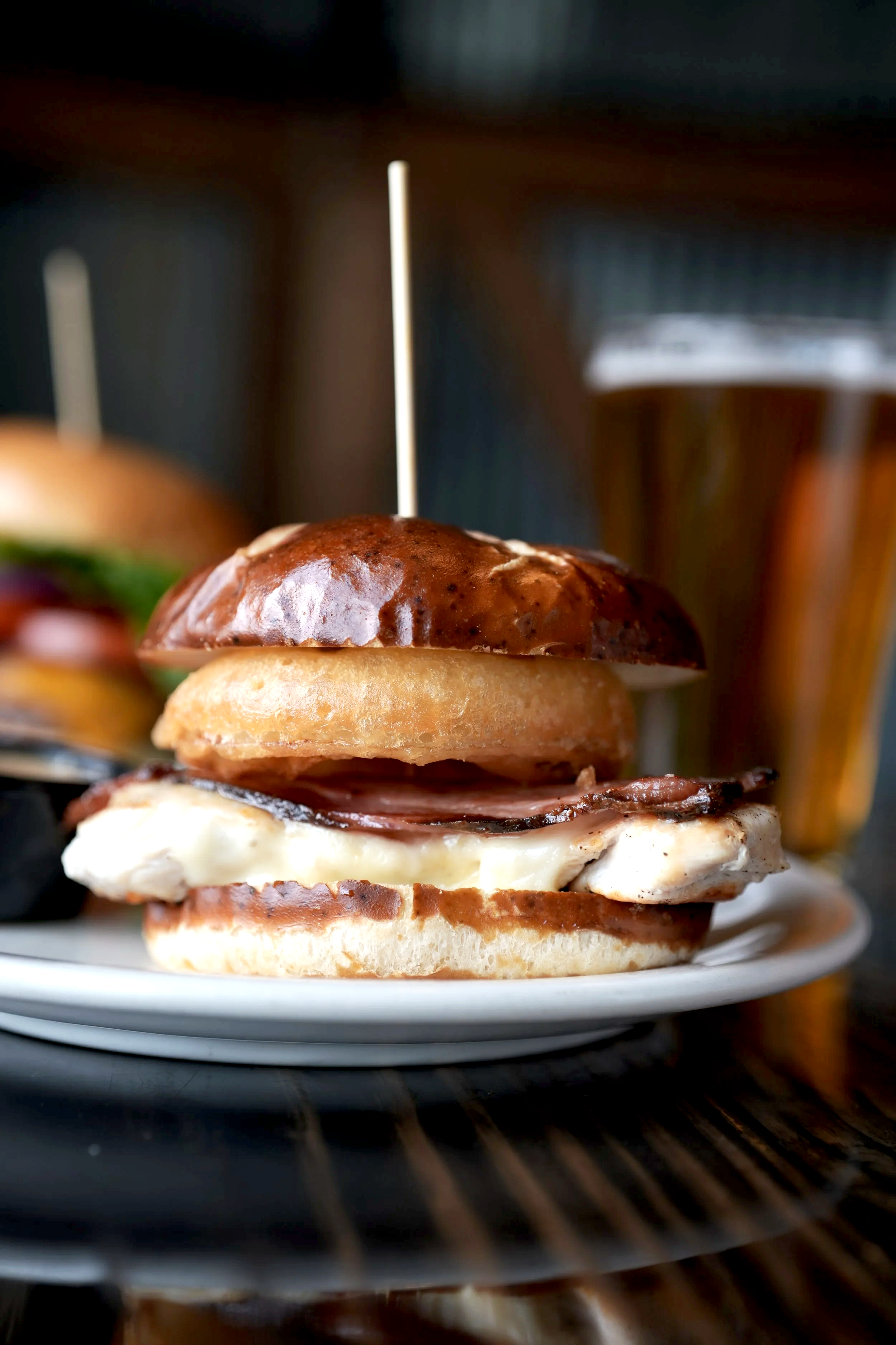 Grilled chicken, cottage bacon, provolone, and a crispy onion ring on a pretzel bun.
