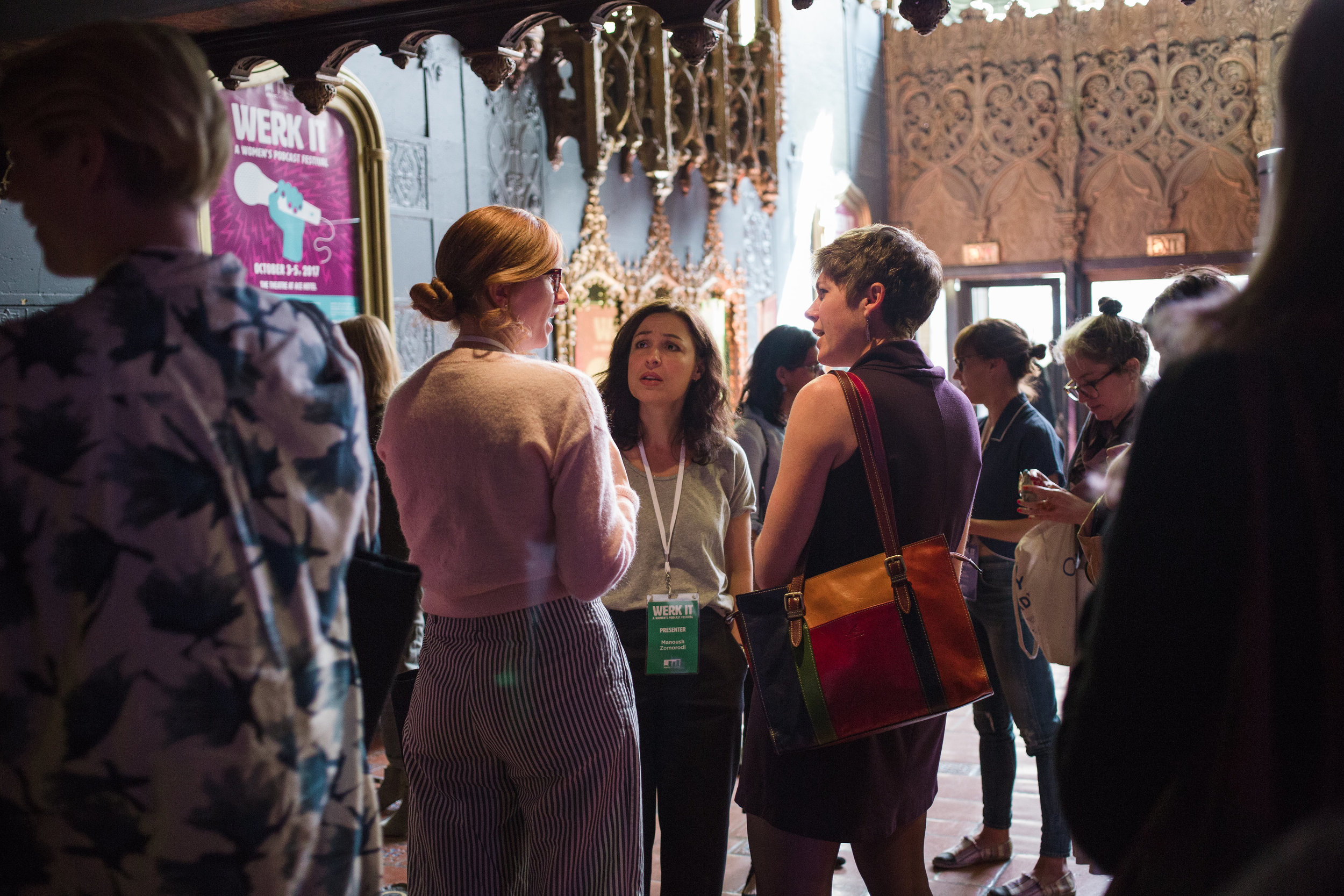 Group of attendees gathered in the venue lobby talking