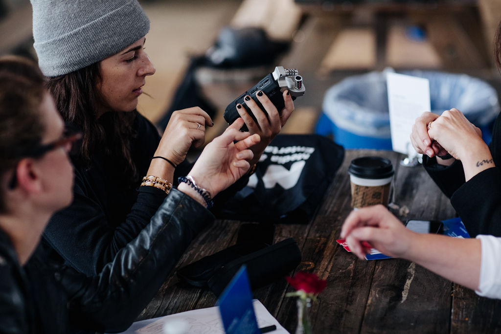 Two attendees examining an audio recorder