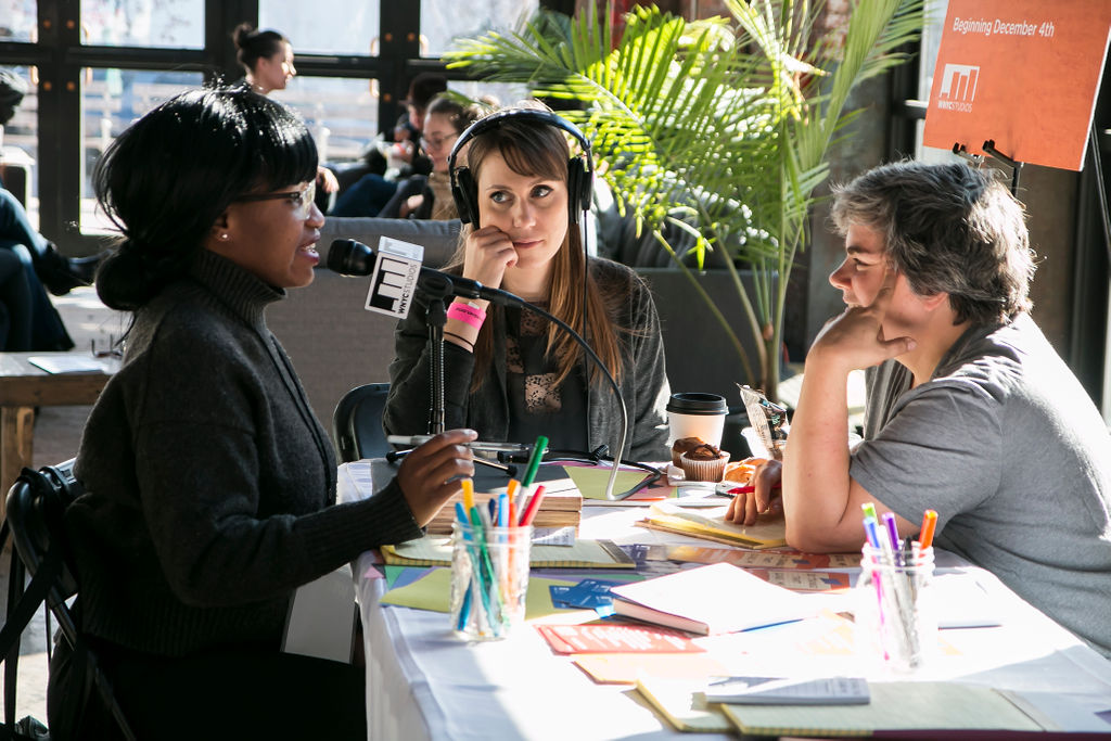 Amy Pear interviewing an attendee for the podcast 10 Things That Scare Me with an audio producer