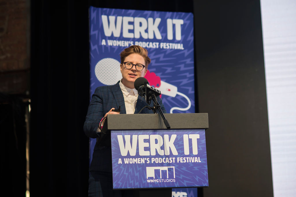 Lauren Ober presenting on stage behind a podium