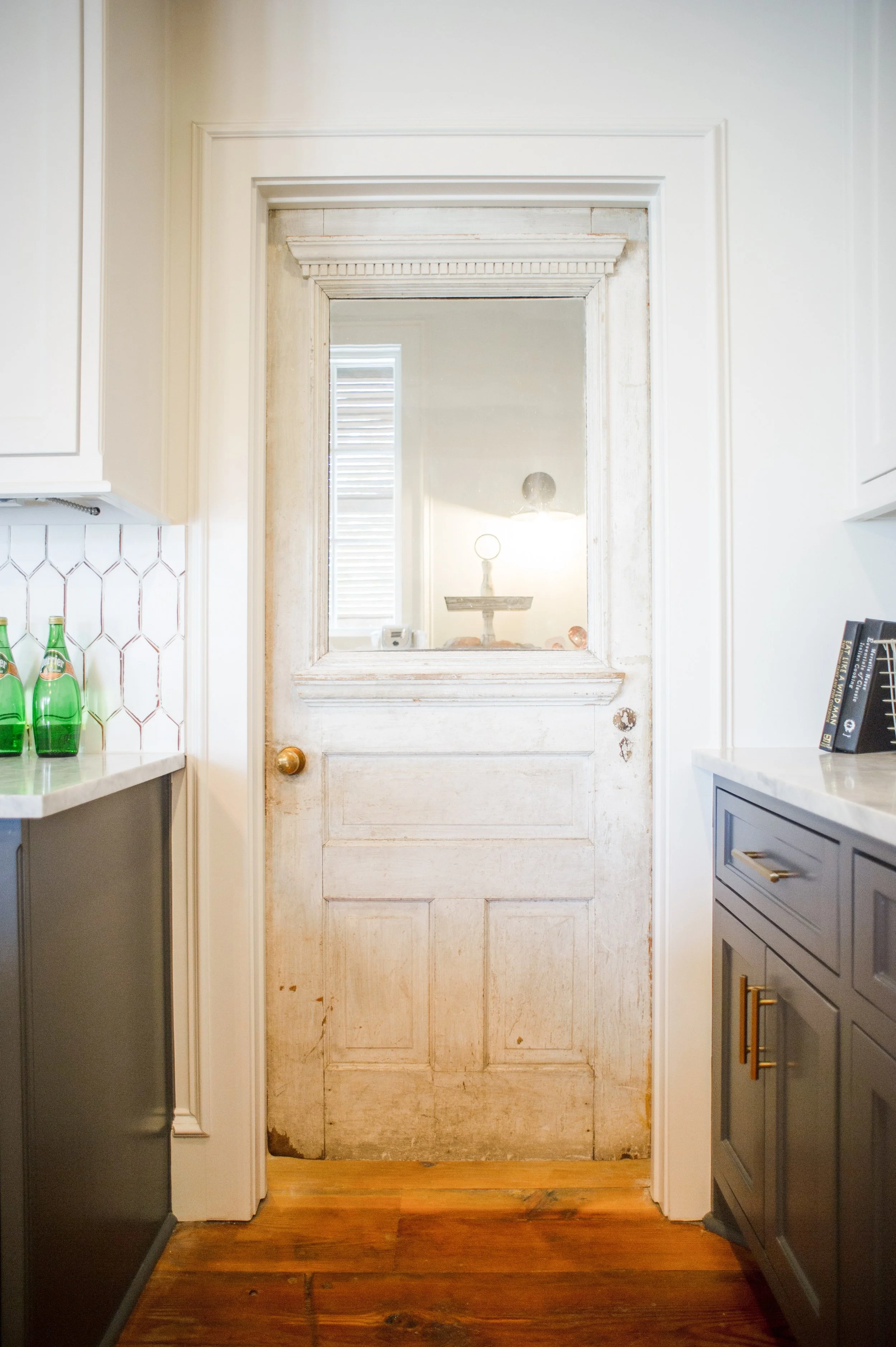 So this gorgeous door had been sitting in the builder's garage for a long time. I said, please can we put this on the pantry??? He agreed. Since the home was custom, the builder could have the pantry opening framed to fit the door.