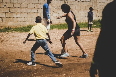 Maya - Playing soccer at VBS with students