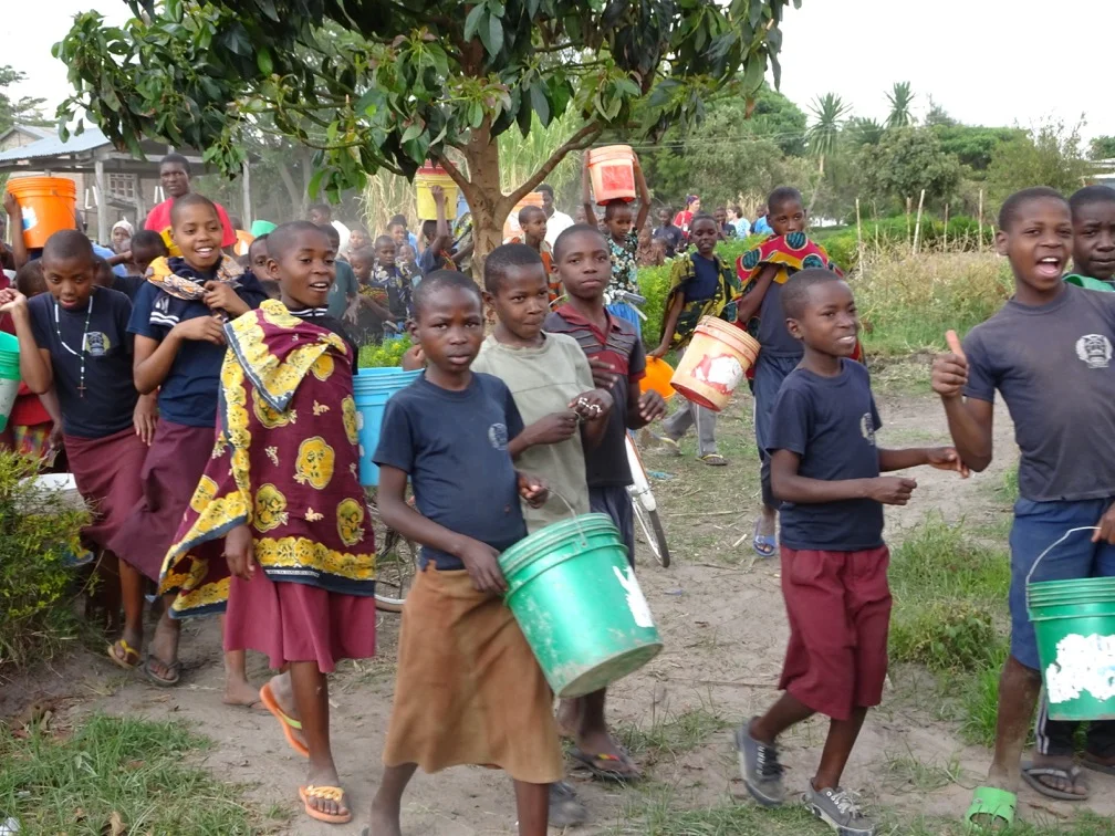 Village children marching to local water hole outside of Ntemba Village in Mvimwa, Tanzania.
