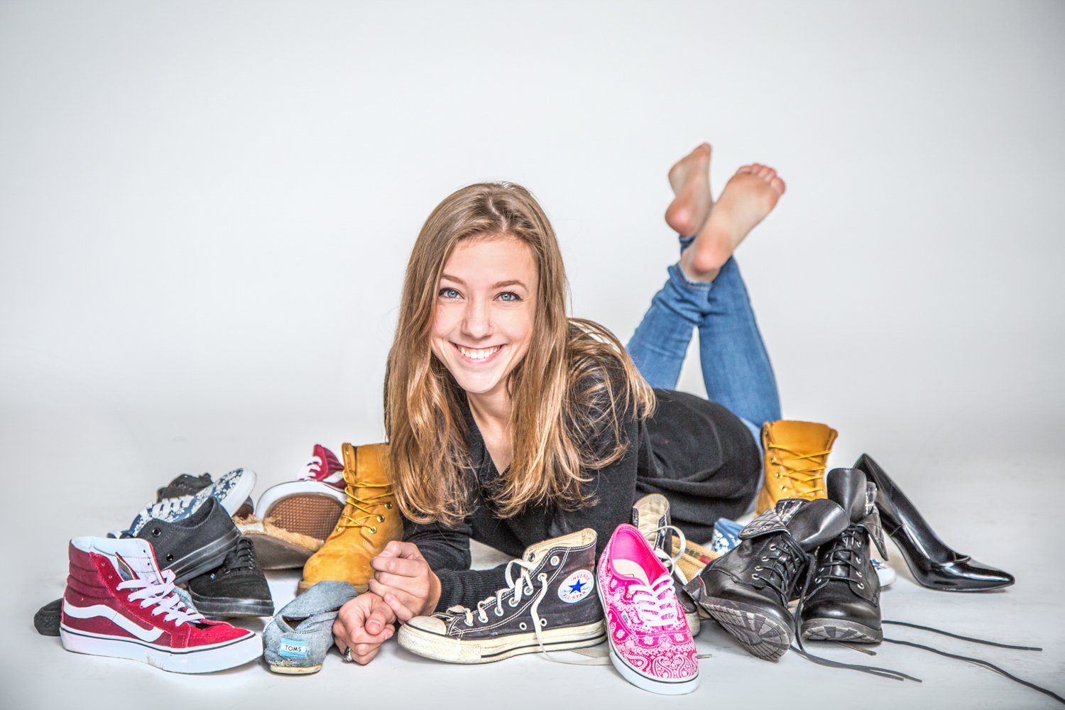 Portrait-HIgh-School-Seniors-girl-smiling-and-happy-surrounded-by-shoes-194.jpg