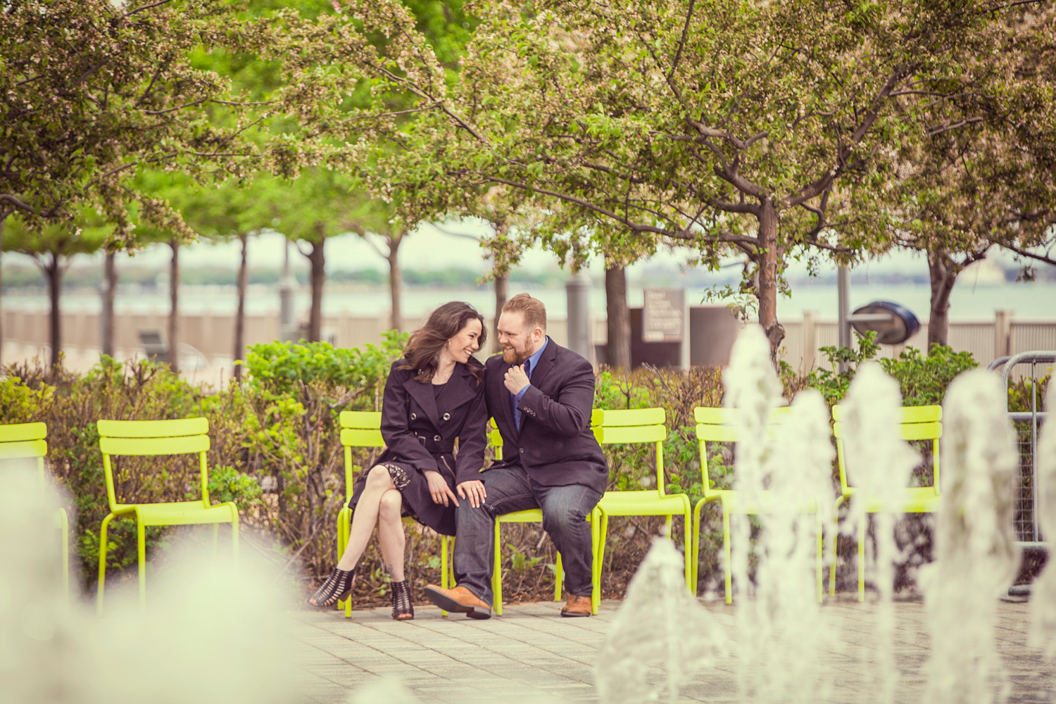 Portrait-Engagement-man-and-woman-in-cafe-on-detroit-riverwalk-with-fountain-173.jpg