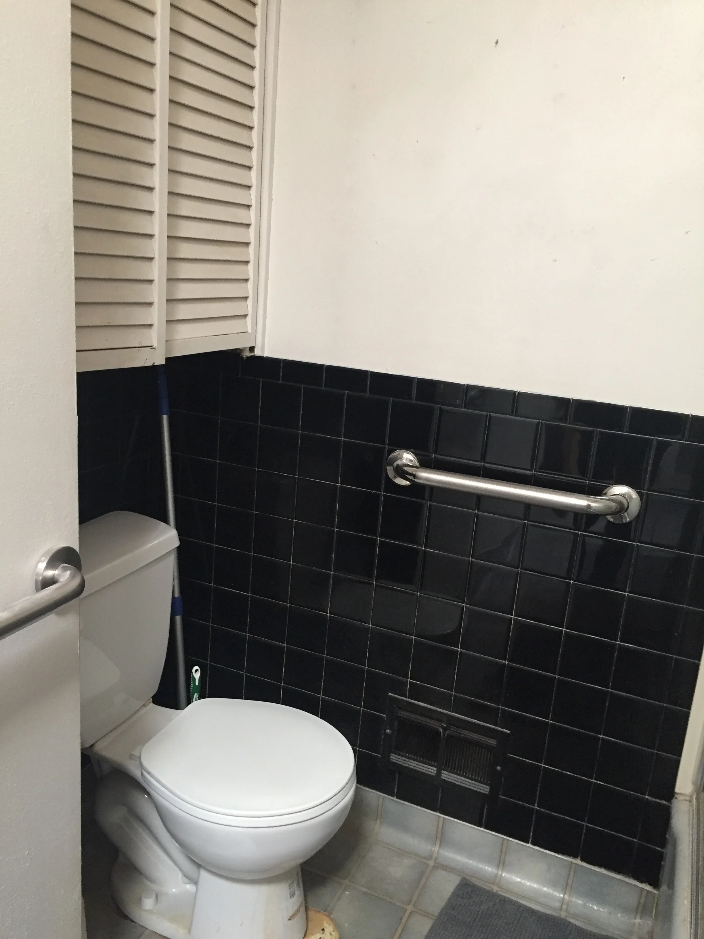 A close-up of the stick-on tiles. This photo also shows the foot of space (where the toilet sits in this photo) that we were able to give to the master bath, which is next door.