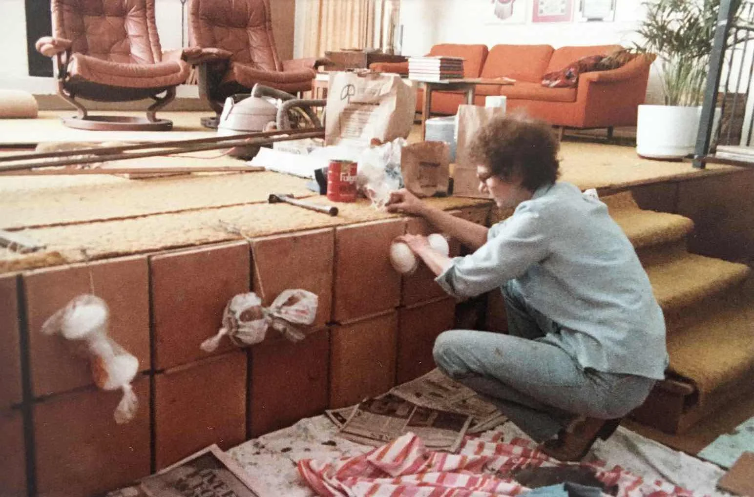 Mrs. Patterson installing the Saltillo tiles after the living room stairs had been relocated.