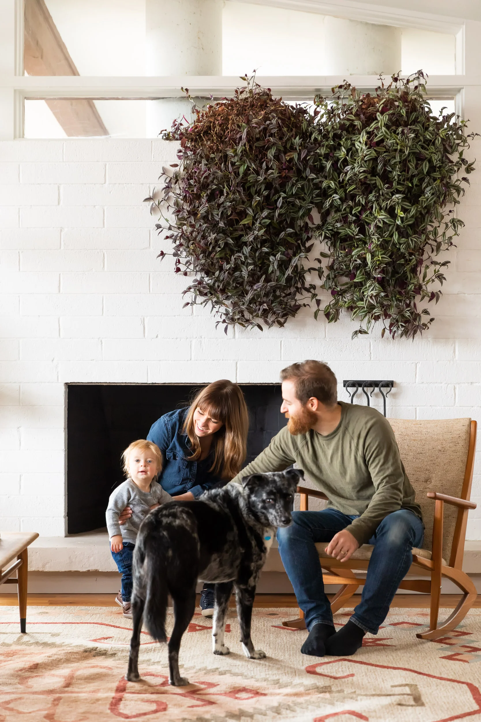 Danielle, Cole, their son, and the family dog in the home’s living area.