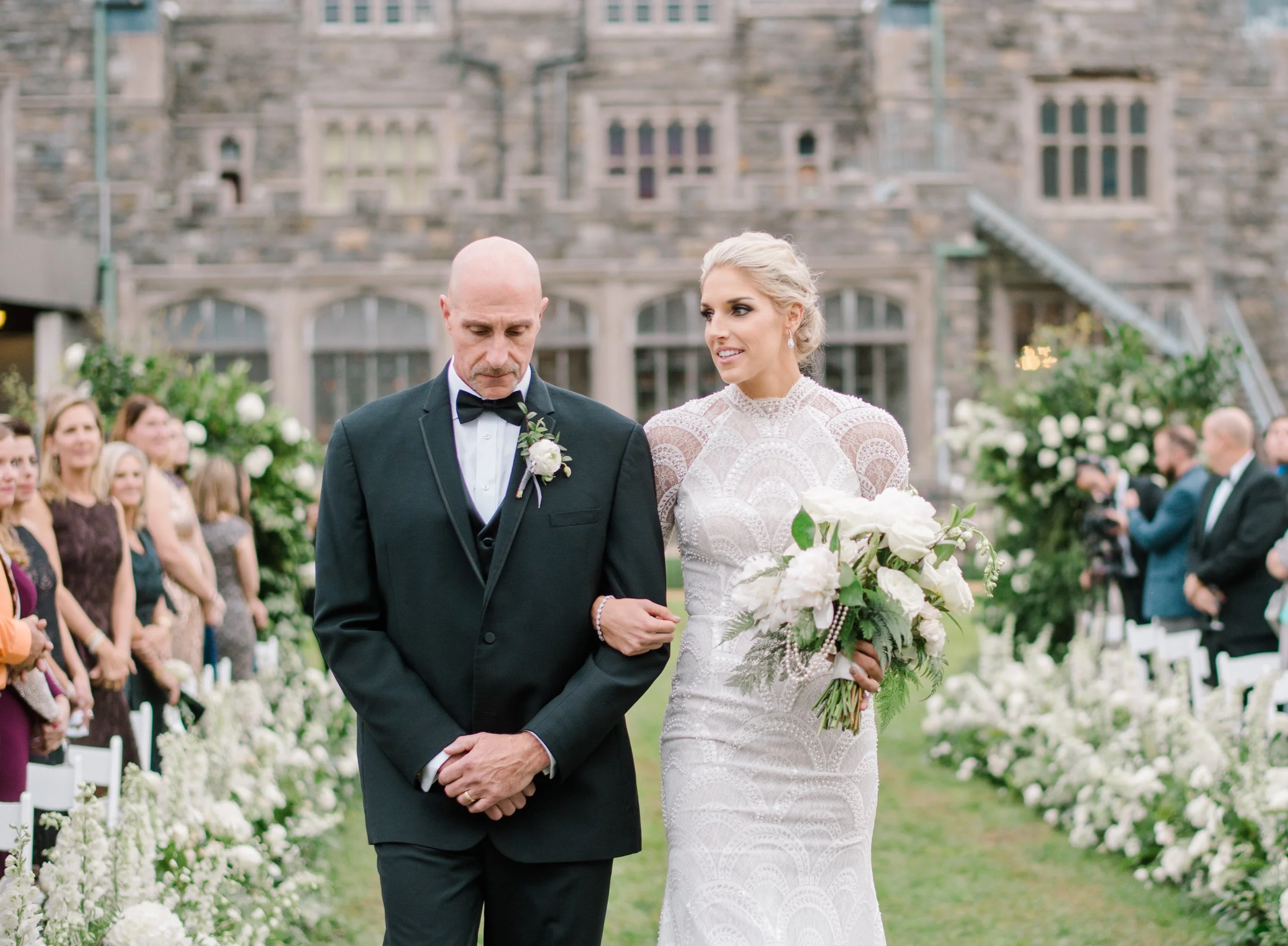 Bride walking down the aisle with her father during The Knot Dream Wedding at Hempstead House, Sands Point, NY. 