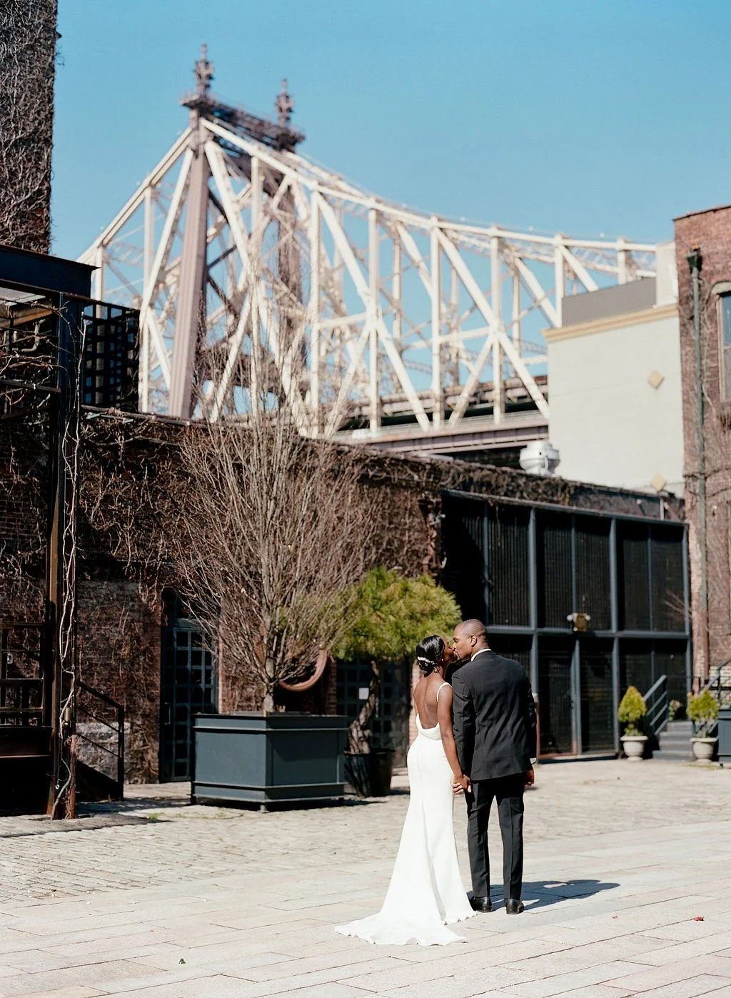 A newly married couple sharing a kiss outside of The Foundry, Long Island City, NY. Luminous Sounds provided music for their entire wedding day. 