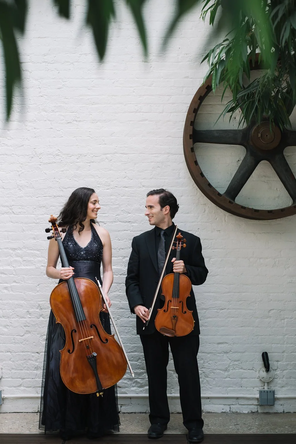 Cellist and Violist ready to play as a string duet for a wedding ceremony in NYC. These musicians are wearing professional performance attire.