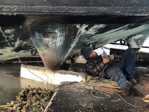 Joe grinds a few rust spots on the rudders and bottom of the fantail. We moved all of Fir's water ballast forward to allow access. 