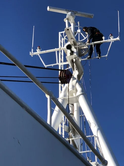 Joe running final wire connections to various equipment on the A Frame (front mast).