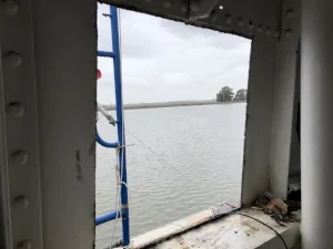 The porthole is cut out using a plasma cutter.