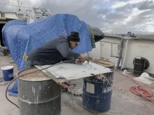 Joe carved the new porthole free-hand. He used a plasma cutter on metal we removed from the lower fantail.