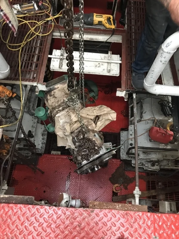 The engine block for generator #2 has been moved to the center of the engine room. The catwalk has been cut out and we are moving it up to deck #2. The block probably weighs 1,000 lbs