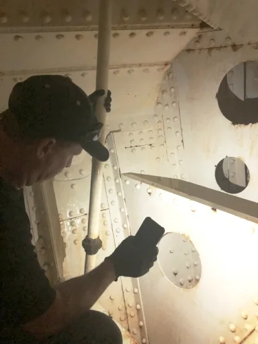 Chris inspects the bow tank after the initial cleaning with Duraprep 88.