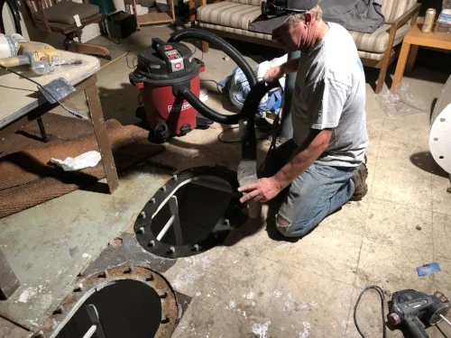 Chris installs new gaskets for the tanks and cleans around the seals.