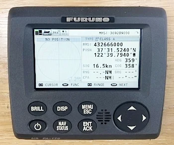 The "head" or display of the Furuno system is mounted to the bulkhead behind the chart table. Historically this is where Fir has mounted the communication systems.