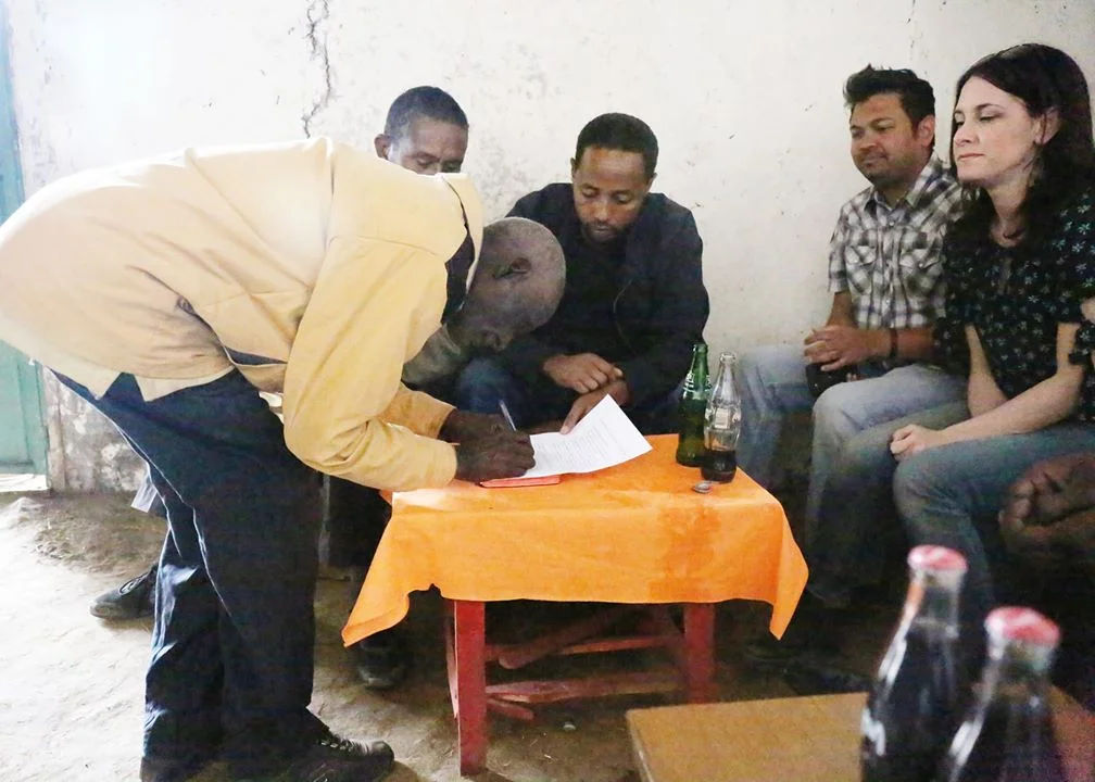 Adanu’s father and mother sign for their child taking back responsibility for her well-being.