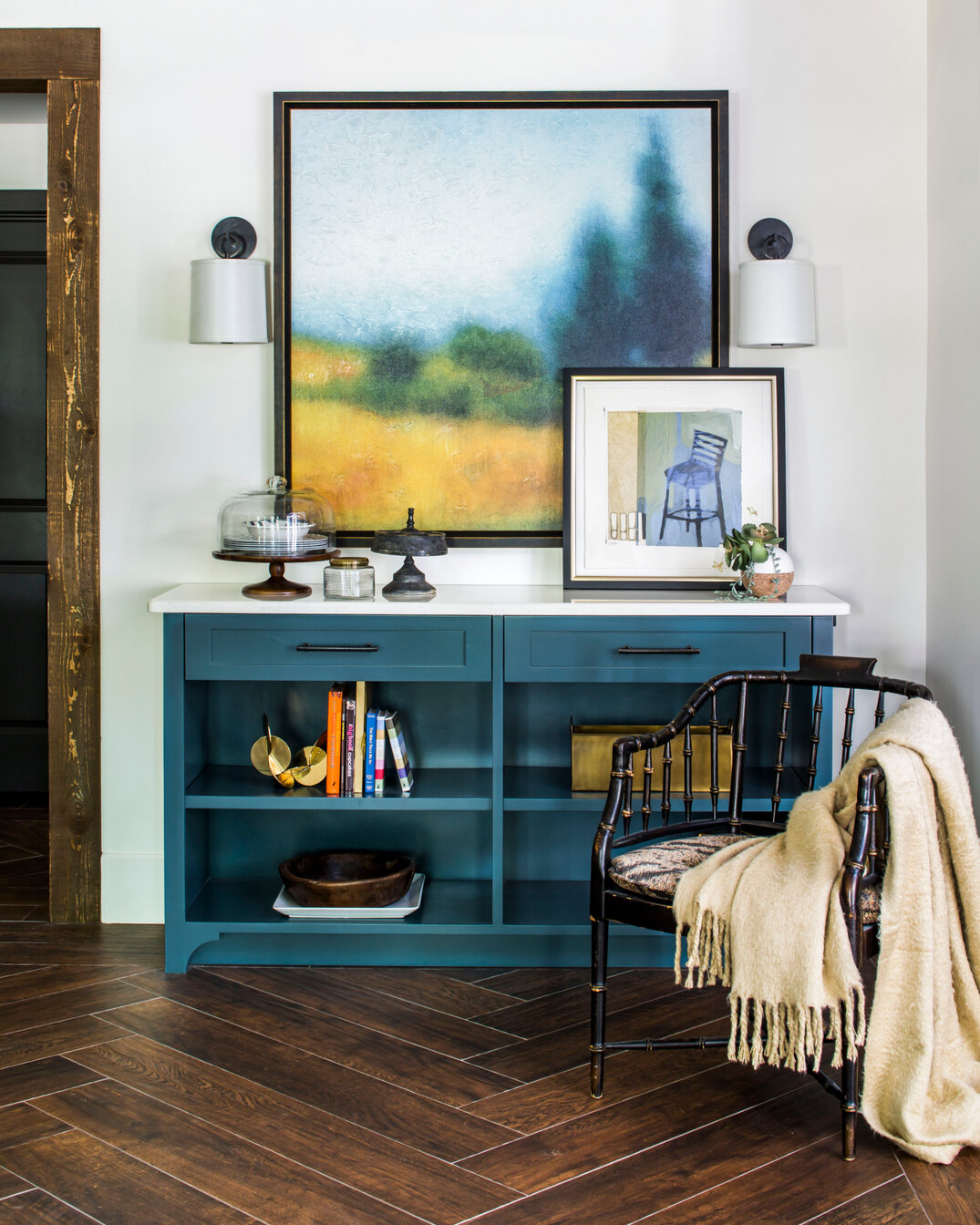 The blue on this open shelving cabinet is beautiful against the chevron wood tile flooring. We were able to incorporate this antique chair found at market which serves as a great place to pause for a cup of tea. Basement living at its best.⠀⠀⠀⠀⠀⠀⠀⠀⠀
