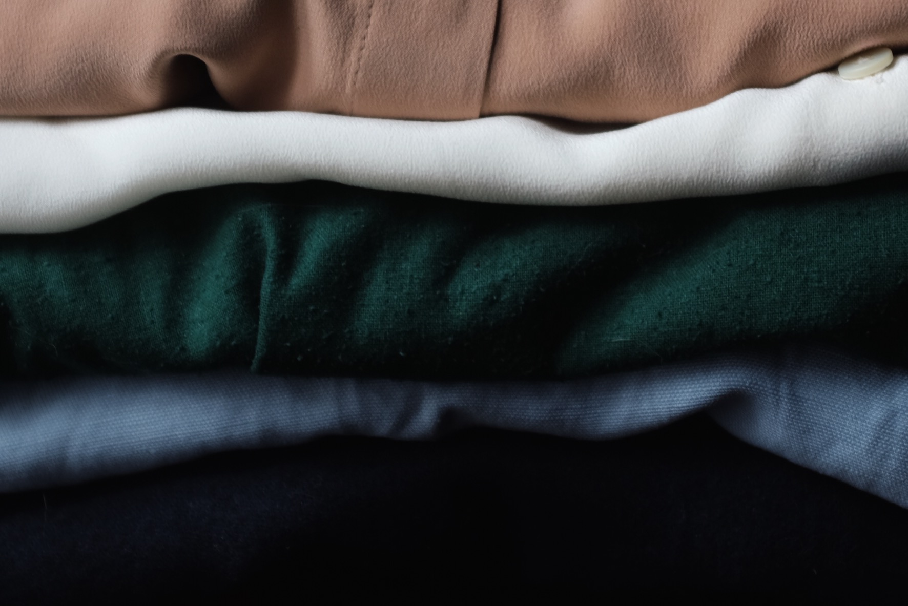 (Top to bottom) Everlane Modern Silk Blouse in Blush, Everlane the Silk Round Collar in White , Jamie + the Jones T Top in Emerald , Reformation Carmen dress in Skye, Elizabeth Suzann Andy Trouser in Navy.