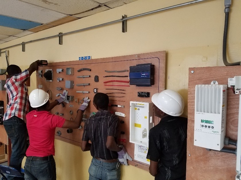 Haiti Tec teachers prepping the classroom with a display board.