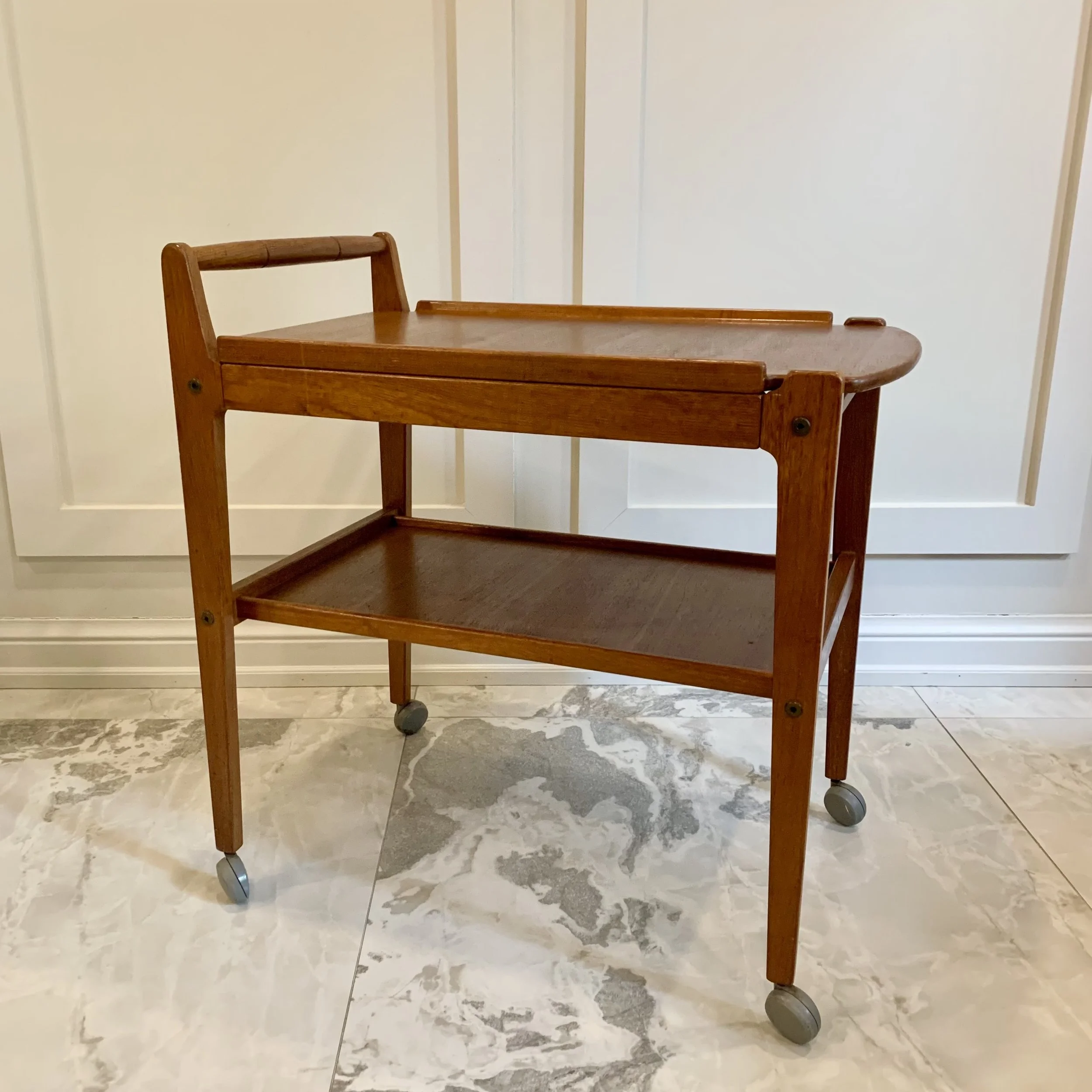  Classic mid-century modern teak bar cart. 26in W x 17in D x 28in H. $265.  