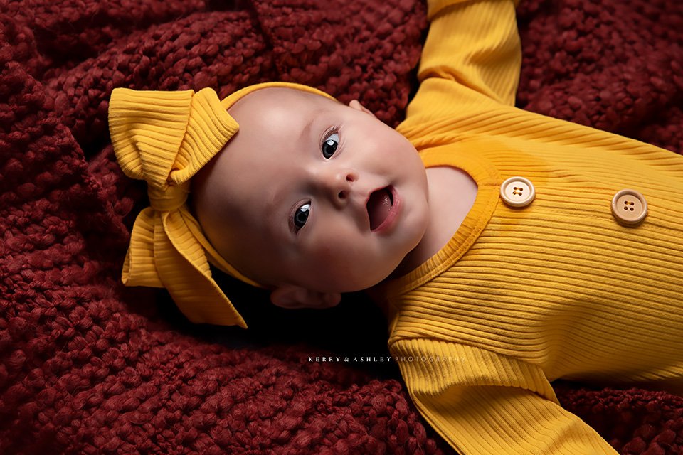 baby-wearing-yellow-knit-onesie.jpg