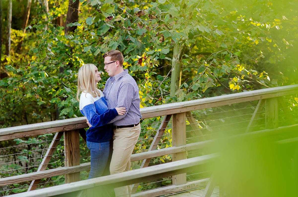 engaged-couple-on-bridge-in-forest.jpg