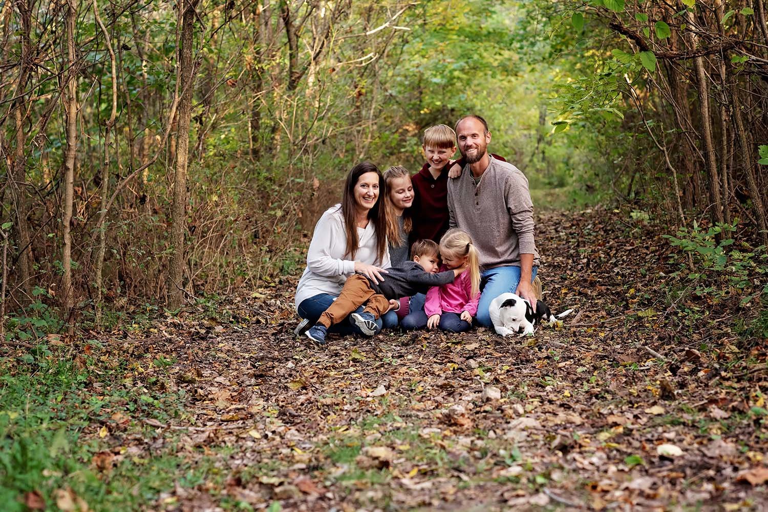 family-of-six-laughing-in-woods.jpg