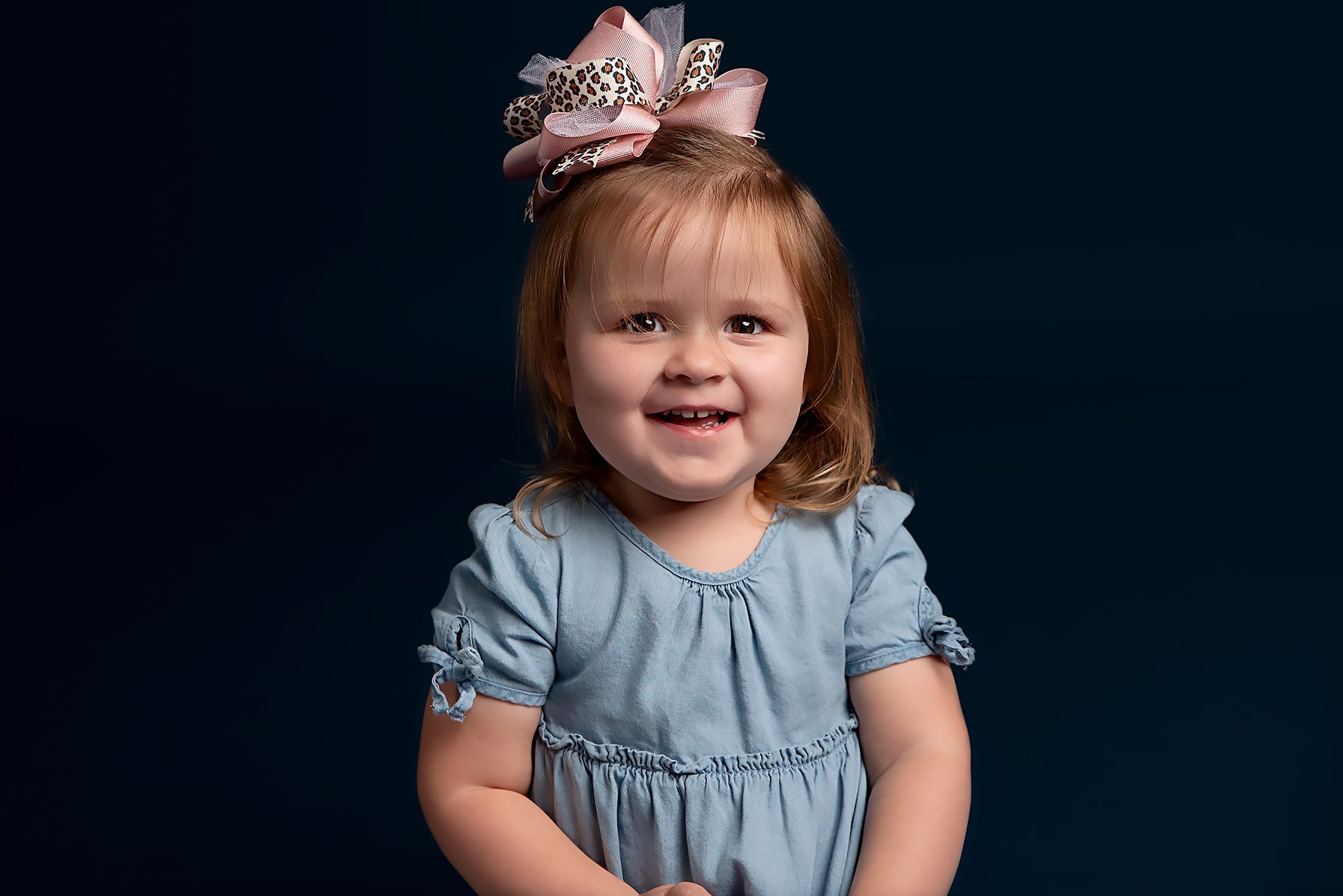 toddler-wearing-blue-dress-big-bow.jpg