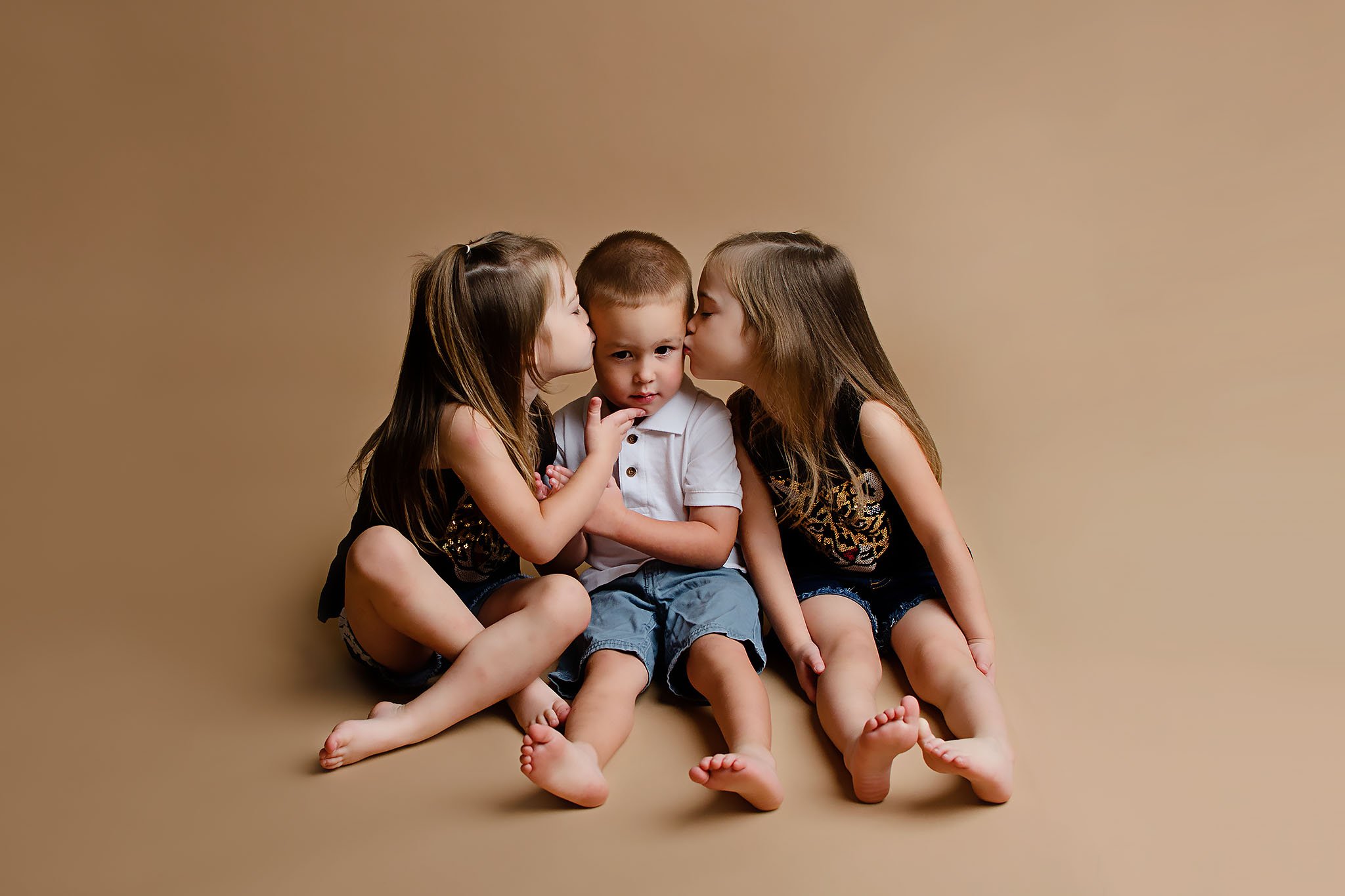 sisters-kissing-triplet-brother.jpg