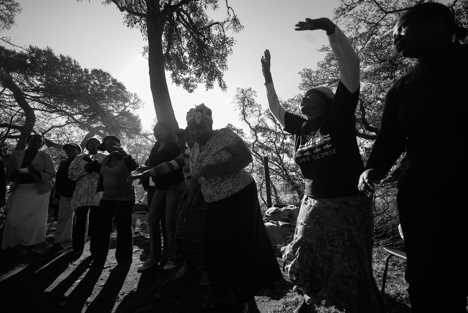 Patients of the treatment centre gather with members of the local community to dance and pray. Although the treatment centre is largely secular most of the patients and the community are christians and they use this as a way to keep the patients sp