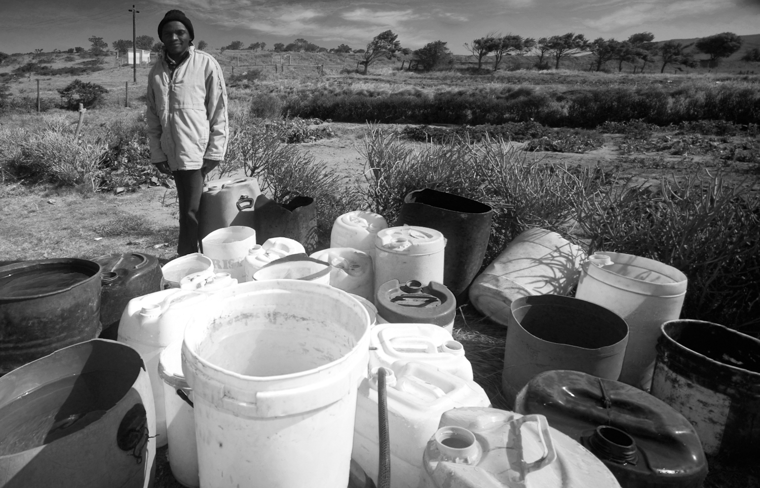 The treatment centre has a vegetable garden that it uses to feed the patients that come to the centre. Here the gardener stands with all the rainwater they collected, which they will use to water the vegetables.