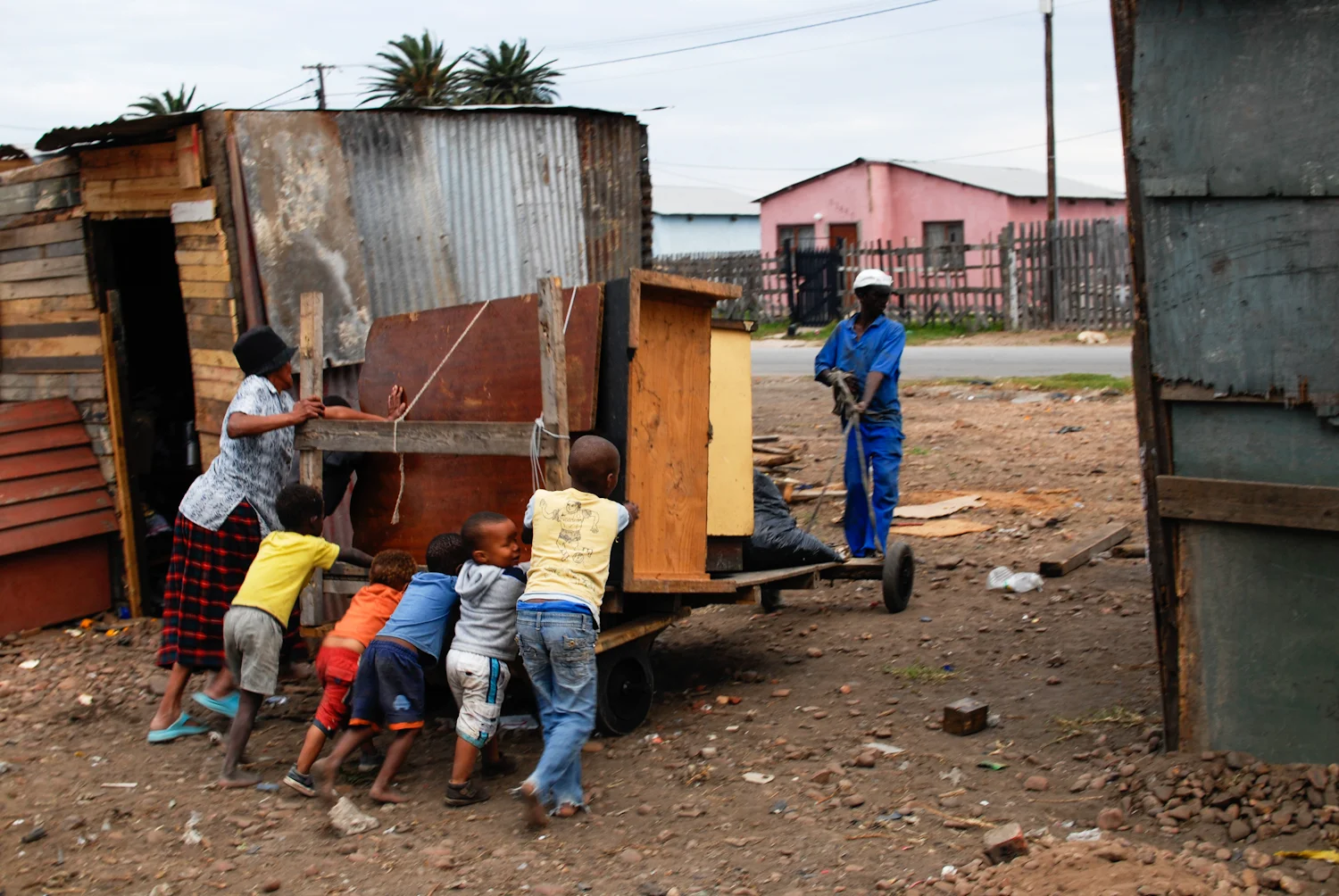 Young children help a family move their belongings