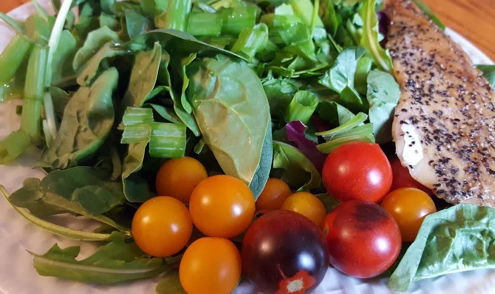 Dark leafy greens with homemade lemon vinaigrette dressing, heirloom cherry tomatoes, and smoked trout.
