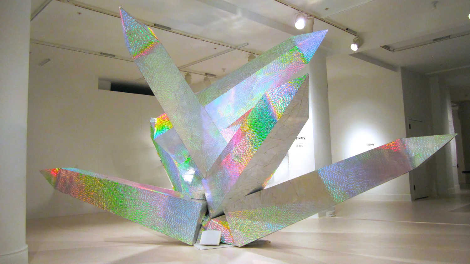 Broken Obelisks , 2013, refractive, dichroic film, foam core, wood, steel, interactive 5.1 sound, 10’ x 12’ x 16’, sound work A holographic skin creates the illusion that the sculpture is undulating and shifting as the viewer moves around it. Commissioned by the Minnesota Museum of American Art