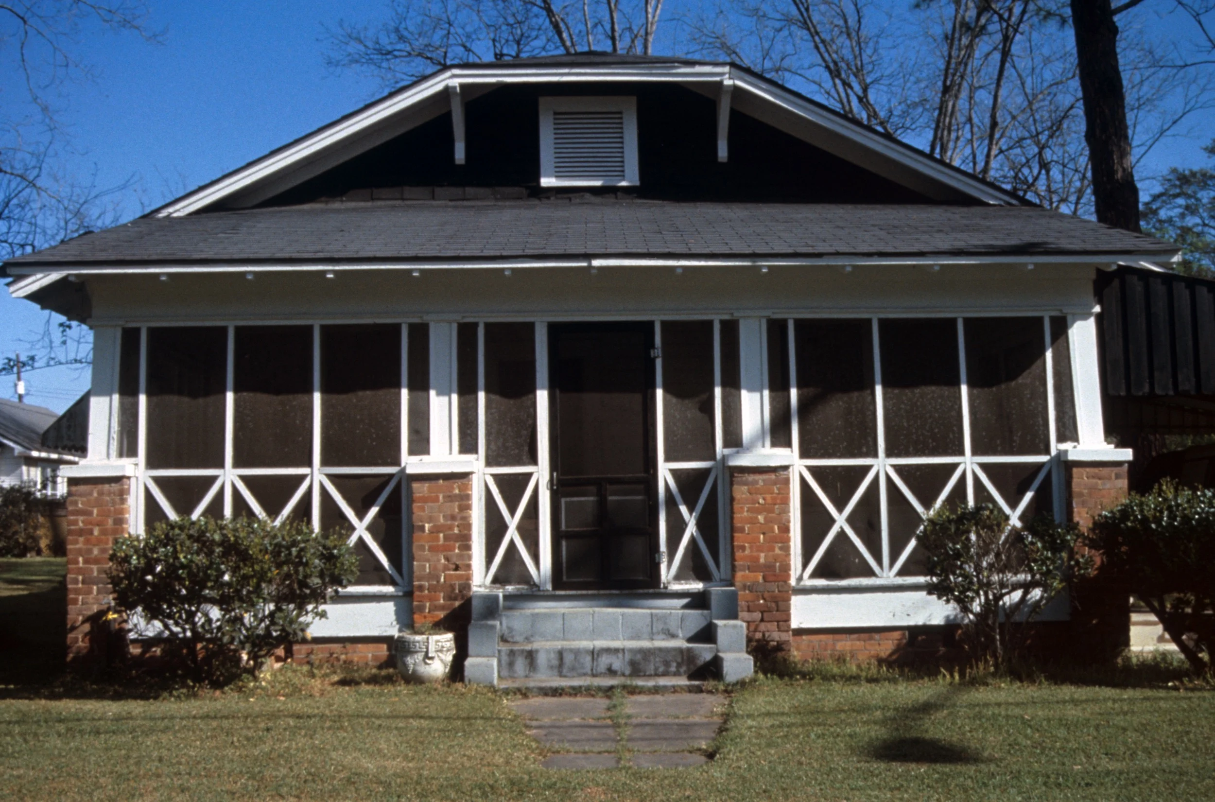 The House of Red on White , 2004, seven room installation, 50‘ x 60‘ x 20’, establishing view, Coleman Art Center, York, AL An interactive community based project where oral histories/folktales of the paranormal were collected by the artist by interviewing members of the community and then realized as site-specific sound and sculpture installations in each room of the house. The folktales served as a metaphor with the work for York’s troubled racial history. Each of the seven rooms contained a separate installation that was derived from folktale collected by the artist. The final room of the installation was the master bedroom which contained the “Stars and Bars” of the Alabama state flag.