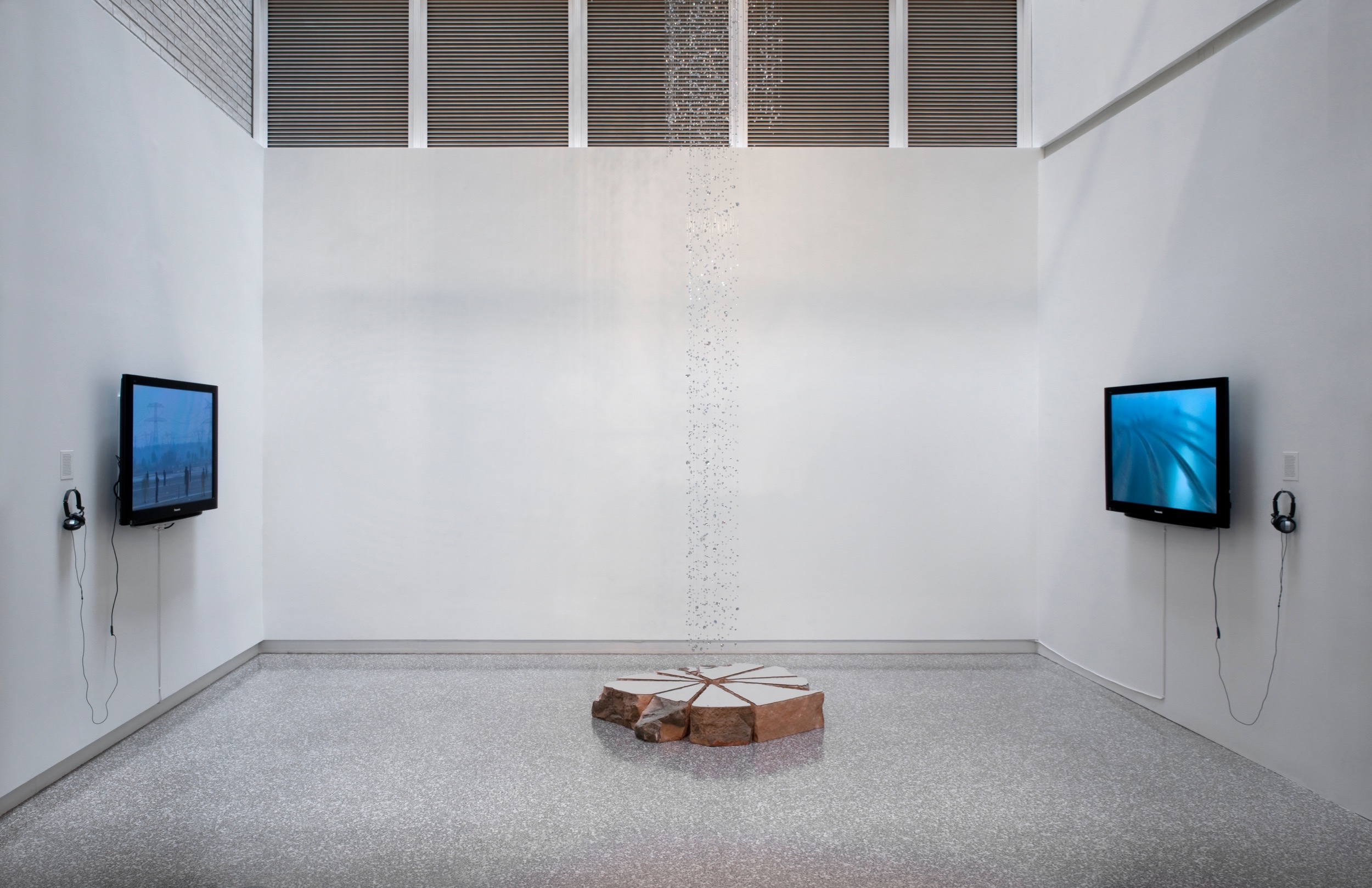 Half a Generation , 2011, mixed media, mirror polished steel, sandstone, two channel video, 30' x 10' x 10, McKnight Fellows Exhibition, MCAD, Minneapolis, MN (video still)