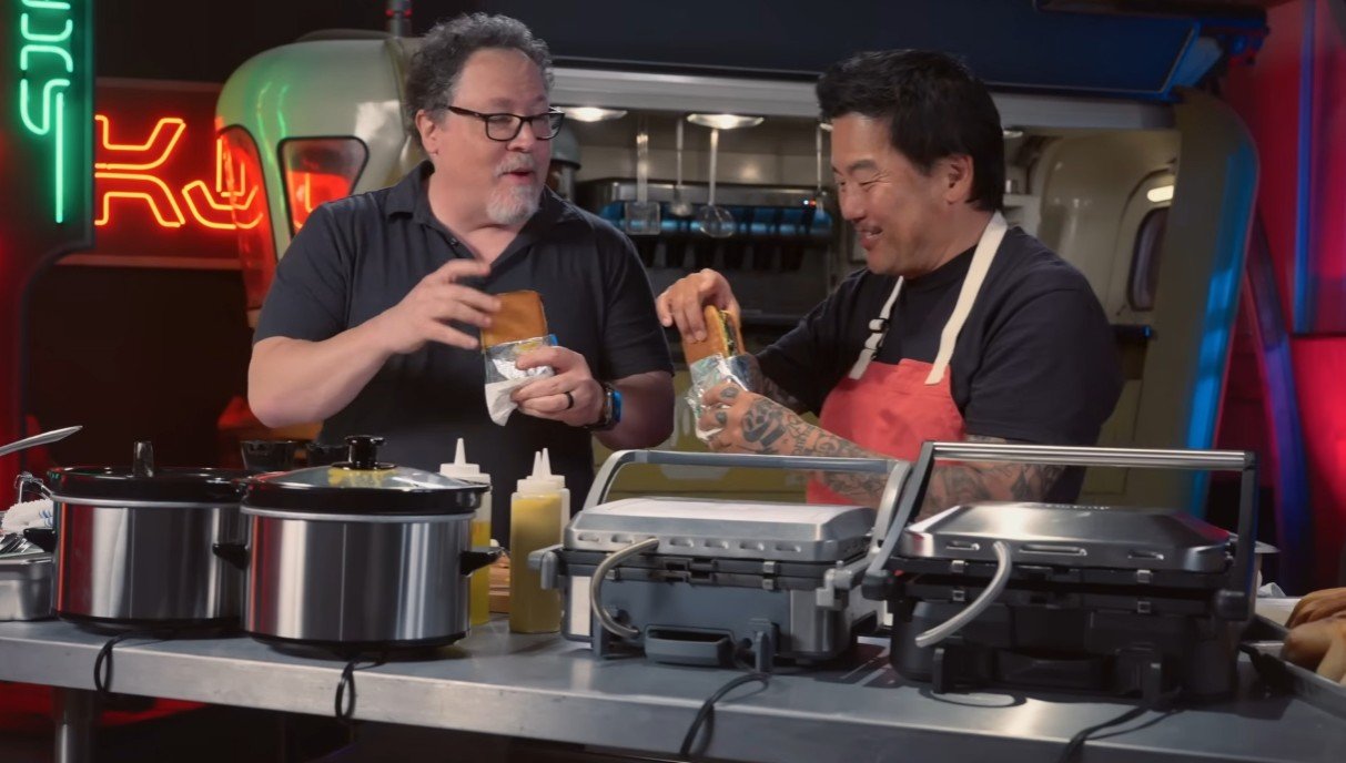 A still from the promo video, where Jon Favreau and Roy Choi enjoy their space-themed sandwiches.