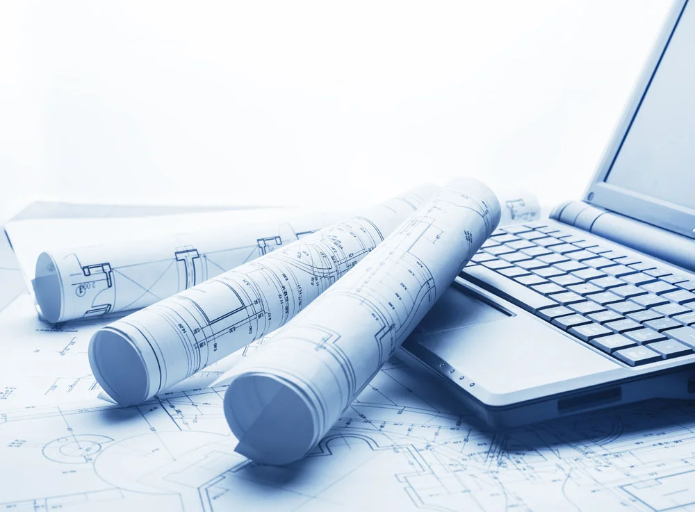 stock-photo-blueprints-and-laptop-175960742.jpg