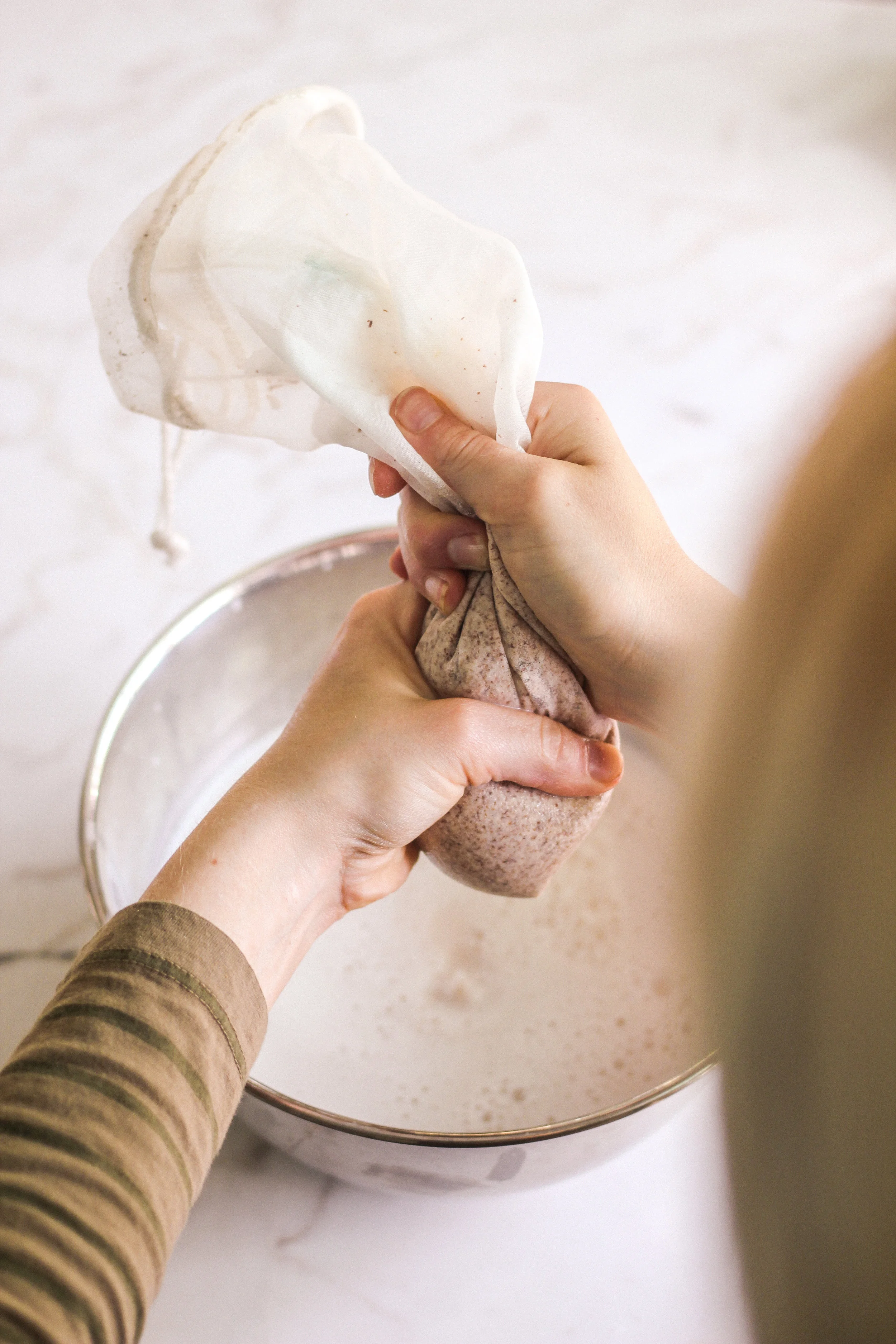 Squeeze your nut milk bag until no more liquid comes out, of course, making sure your hands are clean for this step.